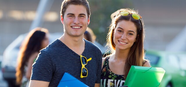 young_students_looking_camera_after_class_site